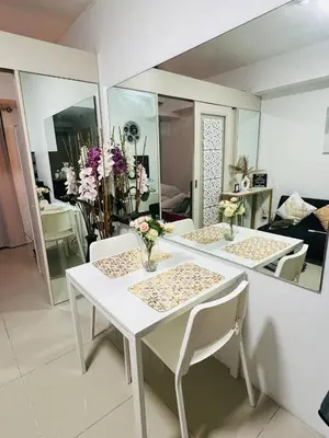 a white table and chairs in a living room at Allie's Cozy Place in Manila