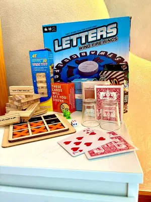 a table with a box of let critters gambling games at Casa de Leon - Azure Urban Resort in Manila
