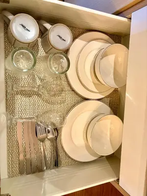 a drawer filled with white plates and utensils at Casa de Leon - Azure Urban Resort in Manila