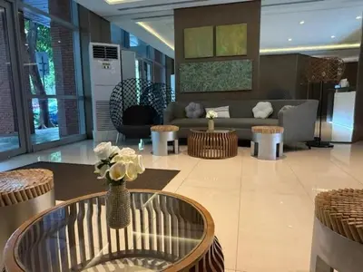 a living room with a couch and a table at Convertible Double Studio in Salcedo Village in Manila