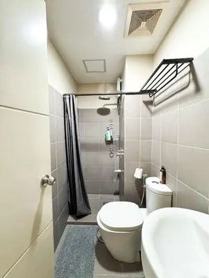 a bathroom with a toilet and a shower at Convertible Double Studio in Salcedo Village in Manila