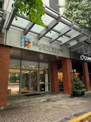 a building with a sign for a shopping center at Convertible Double Studio in Salcedo Village in Manila