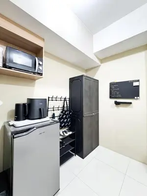 a kitchen with a refrigerator and a microwave at Convertible Double Studio in Salcedo Village in Manila