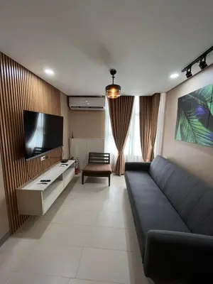 a living room with a couch and a flat screen tv at Antel Spa Residences 15A in Manila