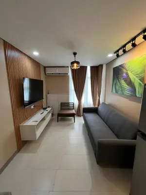 a living room with a couch and a flat screen tv at Antel Spa Residences 15A in Manila