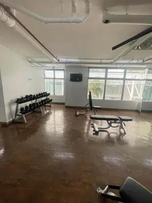 an empty room with a gym with chairs and a screen at Antel Spa Residences 15A in Manila