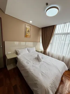 a bedroom with a white bed and a window at Antel Spa Residences 15A in Manila