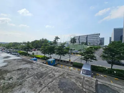 a view of a city with cars parked in a parking lot at SM Mall Of Asia Shore Residences Vianny in Manila