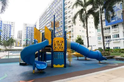 a playground in a city with slides and slidesktop at 2 Bedroom Condo in Front of SM Mall of Asia in Manila