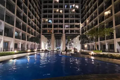 a large pool in the middle of a building at night at Condo in SM Mall of Asia MOA near NAIA Airport in Manila