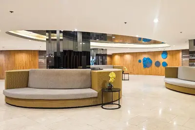 a lobby with a couch in the middle of a room at Condo in SM Mall of Asia MOA near NAIA Airport in Manila