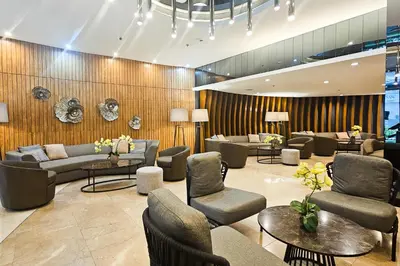 a lobby with couches and chairs and tables at Condo in SM Mall of Asia MOA near NAIA Airport in Manila