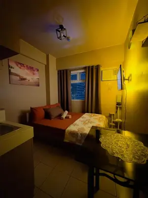 a hotel room with a bed and a window at PaulBert's Cabins I in Manila
