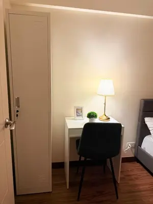 a bedroom with a desk with a lamp and a chair at Staycacia Haven 2BR Condo Maple Acacia Taguig in Manila