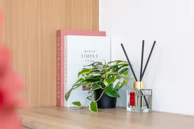 a book sitting on a table next to a potted plant at Stylish Makati 1BR w Balcony Netflix and Fast Wifi in Manila