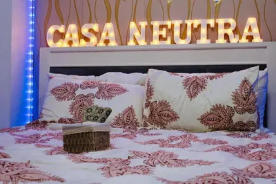 a bed with a sign that reads casa nevina at Casa Neutra - A Cozy Retreat in Manila in Manila