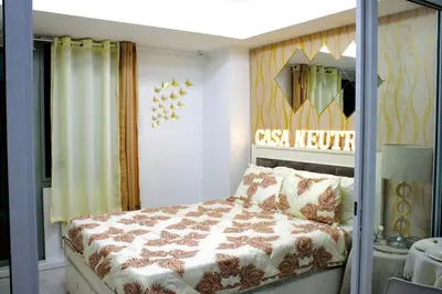 a bedroom with a bed and a sign on the wall at Casa Neutra - A Cozy Retreat in Manila in Manila