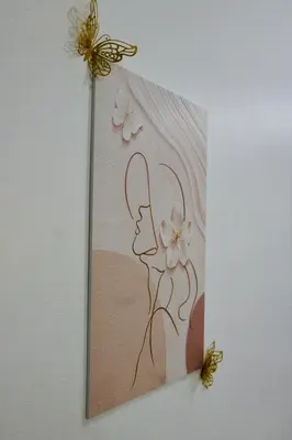 a picture of a woman with flowers on a wall at Casa Neutra - A Cozy Retreat in Manila in Manila
