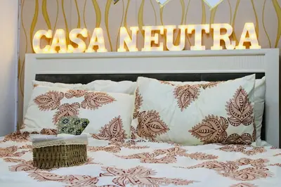 a bed with pillows and a sign that reads casanova at Casa Neutra - A Cozy Retreat in Manila in Manila