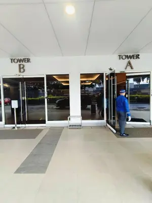 a man standing in the doorway of a store at Shell Residences Mall of Asia by Jhem in Manila