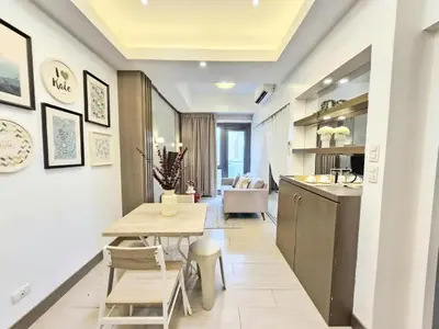 a kitchen and dining room with a table and chairs at Greenbelt Hamilton Residences by ChiKat in Manila