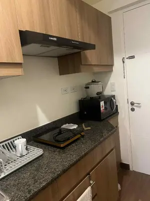 a kitchen with a counter top with a toaster and a microwave at Apartment 28 in Manila