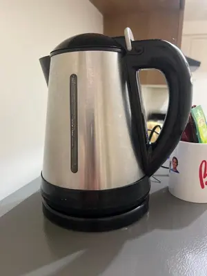 a black and silver tea kettle sitting on a counter at Apartment 28 in Manila