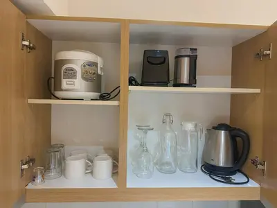 a cupboard filled with lots of kitchen items at Cozy and Aesthetic Vibes - Makati Manila Staycation in Manila