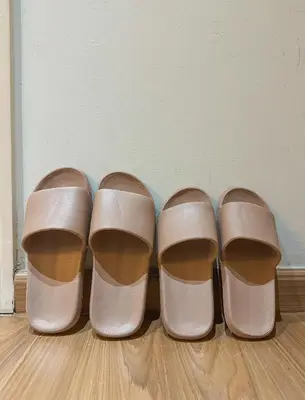 three pairs of shoes sitting on a wooden floor at Cozy and Aesthetic Vibes - Makati Manila Staycation in Manila