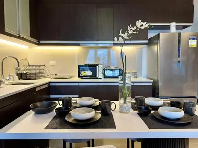 a kitchen with a table with bowls on it at Venice Canal View with Balcony near BGC and Airport 10c in Manila