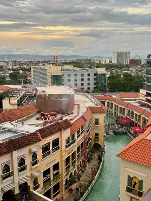 a view of a city with a river and buildings at Venice Canal View with Balcony near BGC and Airport 10c in Manila