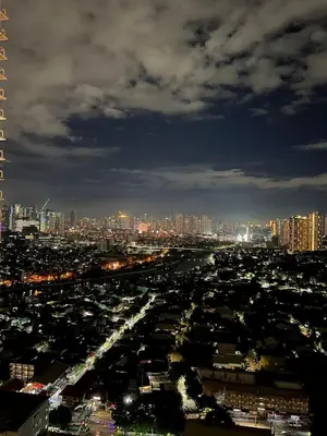 a view of a city at night with at Prisma Residences - 1 Bedroom Paid Parking & Kitchen Near BGC in Manila