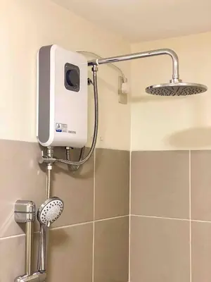 a shower in a bathroom with a soap dispenser at Prisma Residences - 1 Bedroom Paid Parking & Kitchen Near BGC in Manila