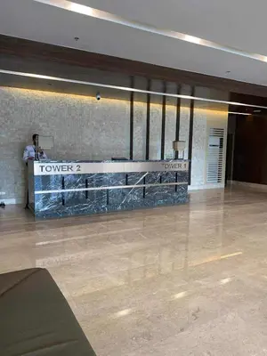 a lobby with a reception desk in a building at JML's Condo at Shore 3 Tower 2 in Manila