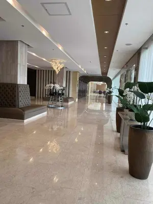a lobby of a building with flowers and tables at JML's Condo at Shore 3 Tower 2 in Manila