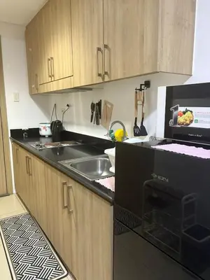 a kitchen with a sink and a microwave at Mall of Asia View Condo Living - Shore in Manila