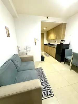 a living room with a couch and a kitchen at Mall of Asia View Condo Living - Shore in Manila