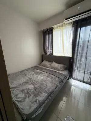 a small bed in a room with a window at Mall of Asia View Condo Living - Shore in Manila