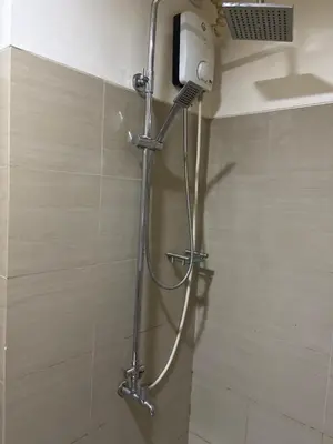 a shower in a bathroom with a metal hose at Mall of Asia View Condo Living - Shore in Manila