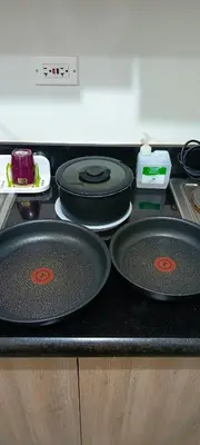 a kitchen counter with two pans on a stove at Marika's Place near Airport, DFA, Mall of Asia and OWWA in Manila