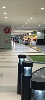 a shopping mall with stools in the middle of it at Marika's Place near Airport, DFA, Mall of Asia and OWWA in Manila