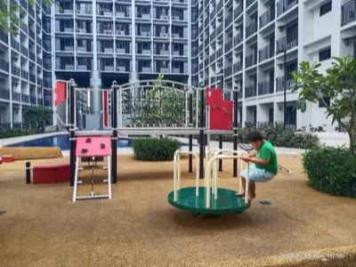 a boy playing on a playground in front of a building at Marika's Place near Airport, DFA, Mall of Asia and OWWA in Manila