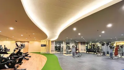a gym with treadmills and exercise equipment in a building at Marika's Place near Airport, DFA, Mall of Asia and OWWA in Manila