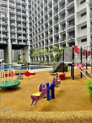 a playground in front of a large building at Marika's Place near Airport, DFA, Mall of Asia and OWWA in Manila