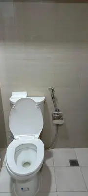 a bathroom with a white toilet in a stall at Marika's Place near Airport, DFA, Mall of Asia and OWWA in Manila