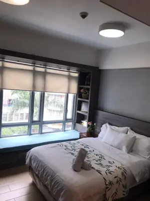 a bedroom with a bed with a teddy bear on it at Newport Condo near T3 - H in Manila
