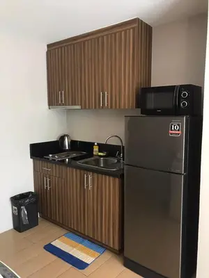 a kitchen with a black refrigerator and a sink at Newport Condo near T3 - H in Manila