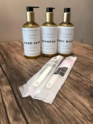 four bottles of hand sanitizer on a wooden table at Newport Condo near T3 - H in Manila
