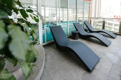 a row of chairs in a building with a pool at LivStudios Manila Bay in Manila