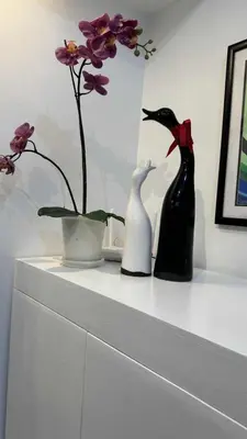 three vases sitting on a white shelf with flowers at 1BR Pioneer Woodland Condominium connected to BONI Metro Rail Station,Boni Mandaluyong Metro Manila in Manila